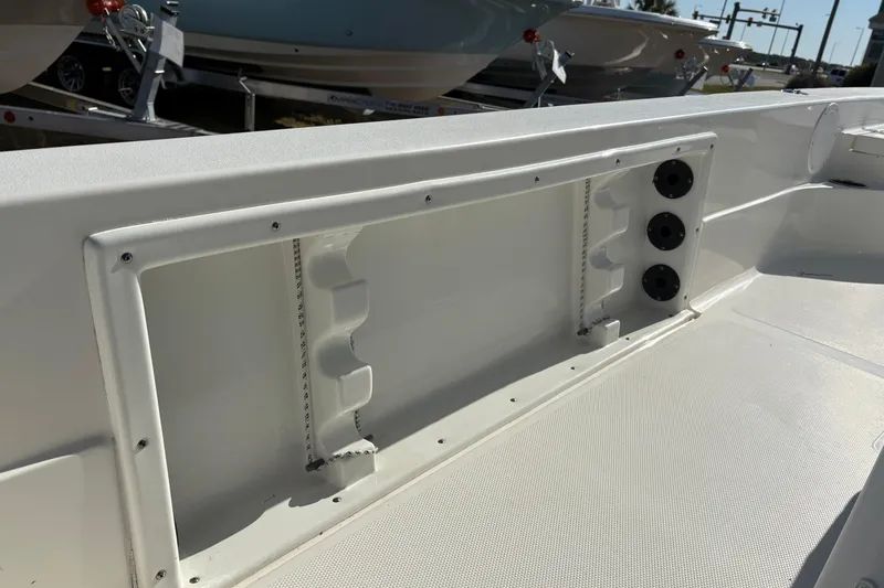 Slide: The Image of 2021 NauticStar 227 XTS boat interior detail with rod holders and storage compartment. - 21