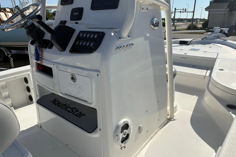 Slide: The Image of 2021 NauticStar 227 XTS boat console with steering wheel and control panel. - 22