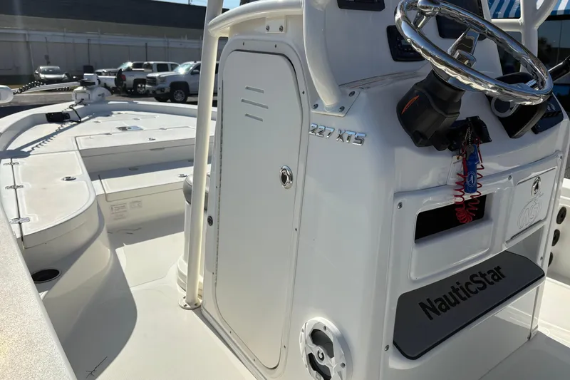 Slide: The Image of 2021 NauticStar 227 XTS boat interior with steering wheel and console details. - 23