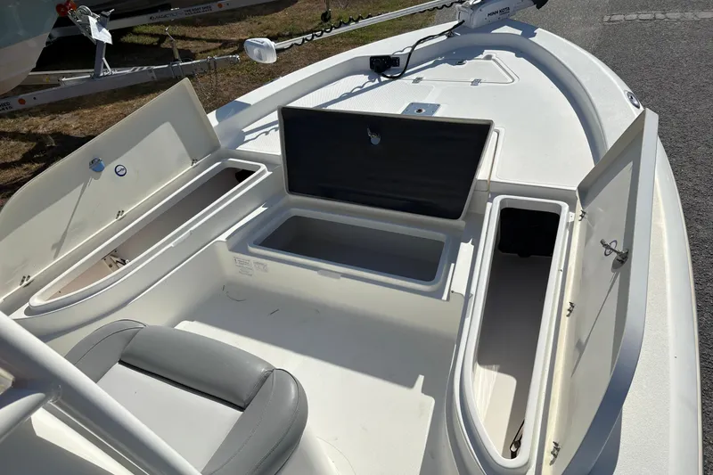 Slide: The Image of 2021 NauticStar 227 XTS boat with open storage compartments and seating. - 25