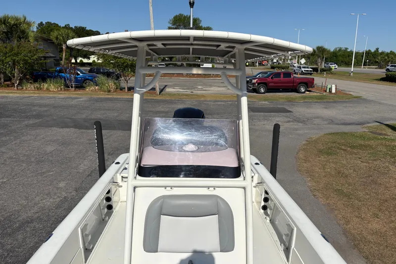 Slide: The Image of 2021 NauticStar 227 XTS boat with T-top, parked on asphalt. - 28