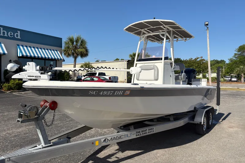 Slide: The Image of 2021 NauticStar 227 XTS boat on trailer, parked outside a building. - 6
