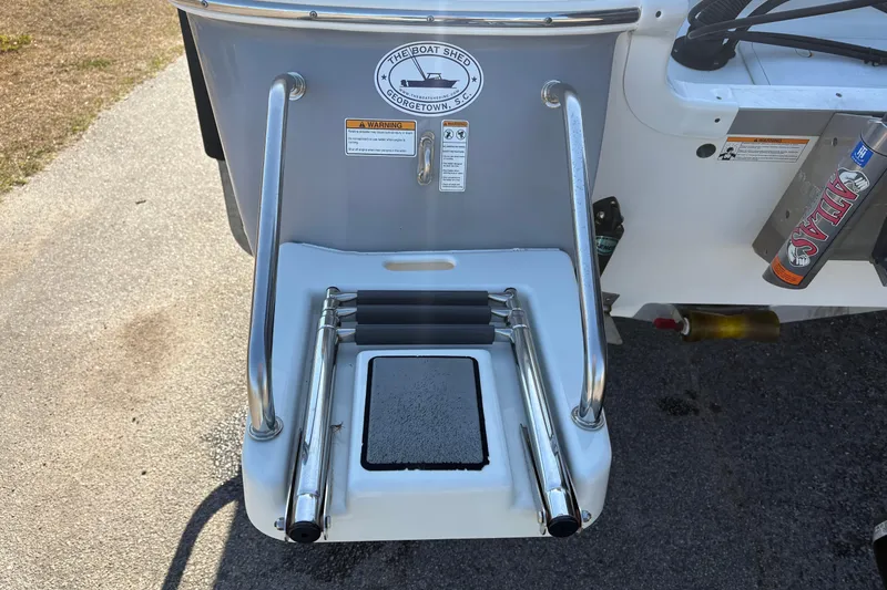 Slide: The Image of 2021 NauticStar 227 XTS boat ladder and platform on a sunny day. - 7