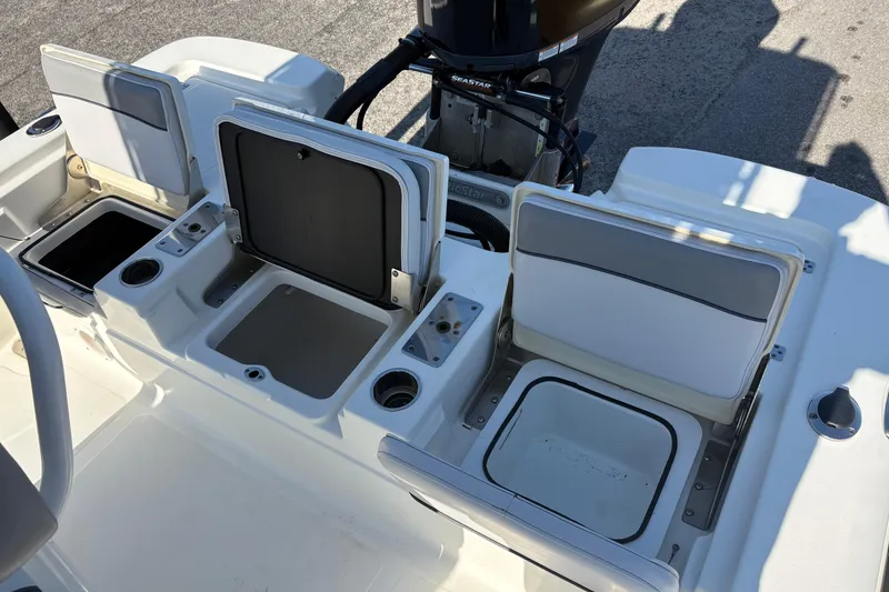 Slide: The Image of 2021 NauticStar 227 XTS boat interior with open storage compartments and seating. - 9