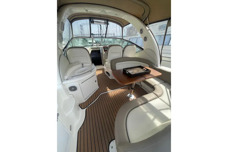 Slide: The Image of Interior of 2003 Sea Ray 340 Sundancer yacht with seating and wooden table. - 11