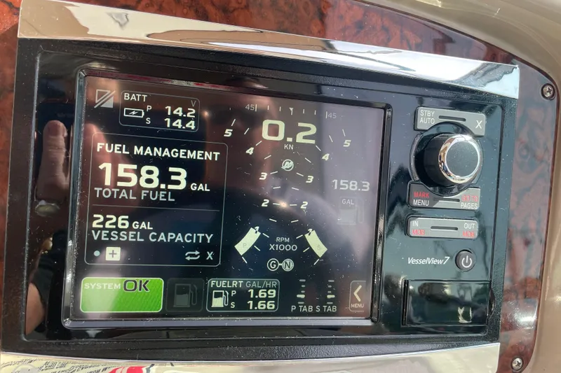 Slide: The Image of Dashboard of a 2003 Sea Ray 340 Sundancer showing fuel management and vessel capacity. - 23