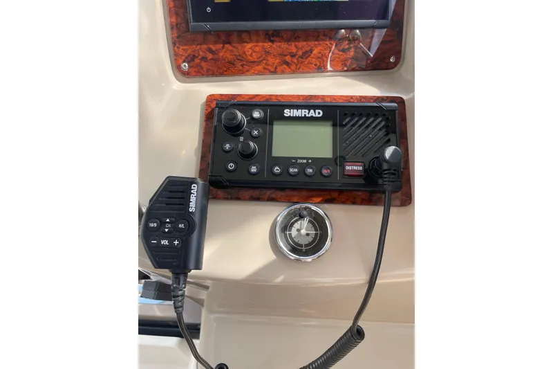 Slide: The Image of Simrad marine radio system on 2003 Sea Ray 340 Sundancer boat dashboard. - 24