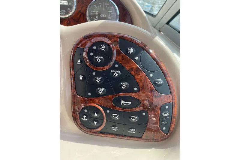 Slide: The Image of Control panel of a 2003 Sea Ray 340 Sundancer boat with various function buttons. - 27