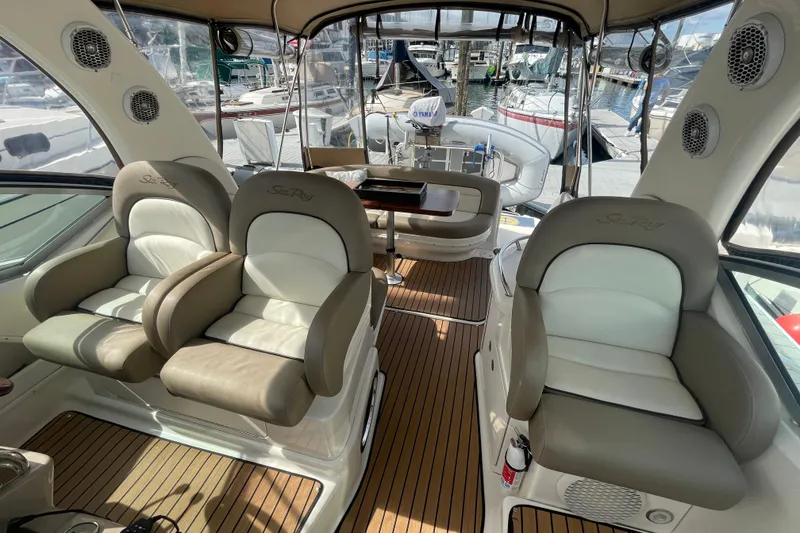 Slide: The Image of Interior of 2003 Sea Ray 340 Sundancer yacht with plush seating and wood flooring. - 29