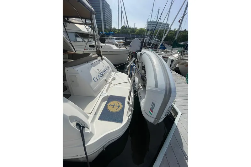 Slide: The Image of 2003 Sea Ray 340 Sundancer docked with inflatable boat attached at marina. - 3