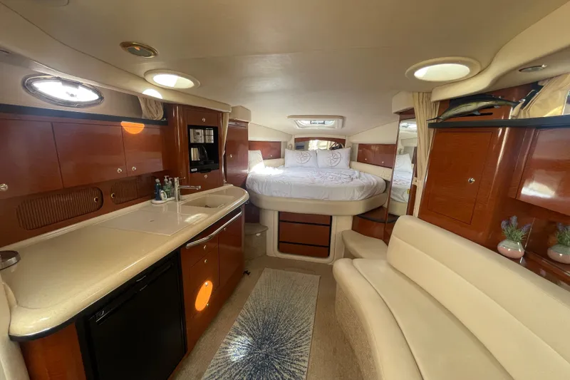 Slide: The Image of Luxurious interior of 2003 Sea Ray 340 Sundancer yacht with cozy bed and kitchenette. - 31