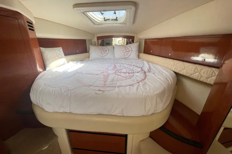 Slide: The Image of Luxurious cabin interior of 2003 Sea Ray 340 Sundancer yacht with compass-themed bedding. - 37