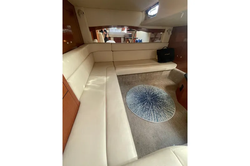Slide: The Image of Interior of 2003 Sea Ray 340 Sundancer yacht with beige seating and decorative rug. - 40