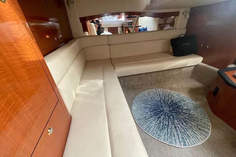 Slide: The Image of Interior of 2003 Sea Ray 340 Sundancer yacht with beige seating and wooden cabinetry. - 41
