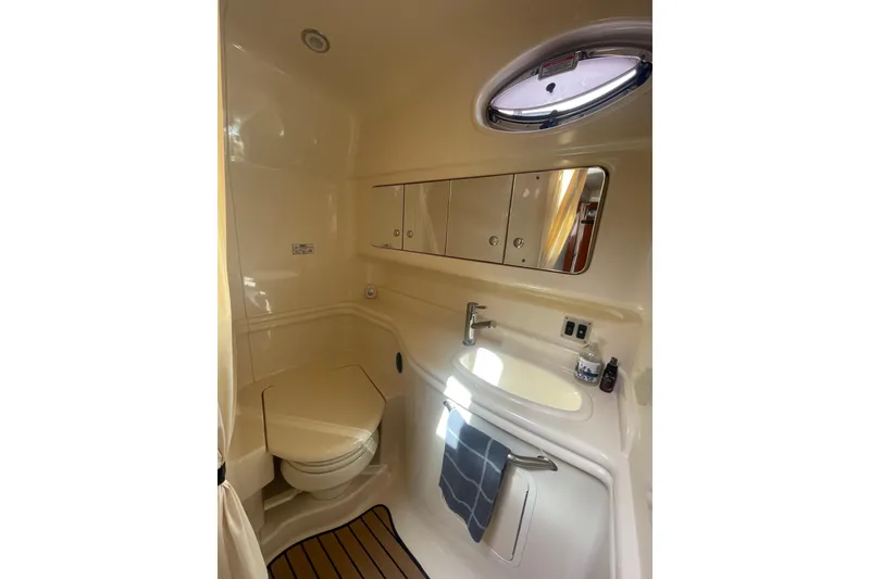 Slide: The Image of Luxurious bathroom in 2003 Sea Ray 340 Sundancer yacht with sink, toilet, and storage. - 42