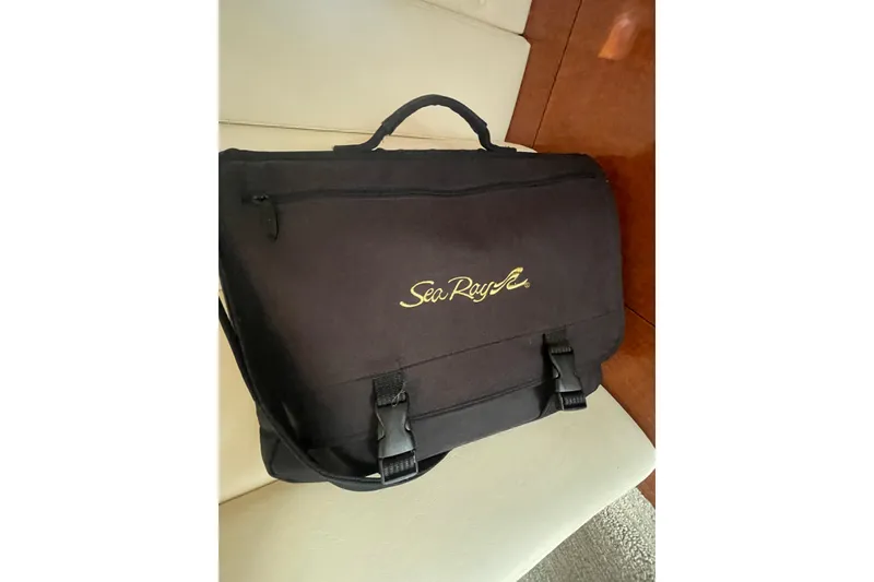 Slide: The Image of Black Sea Ray branded bag on a boat seat, showcasing the 2003 Sea Ray 340 Sundancer. - 46