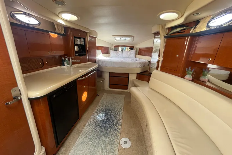 Slide: The Image of Luxurious interior of 2003 Sea Ray 340 Sundancer yacht with kitchenette and cozy seating area. - 48