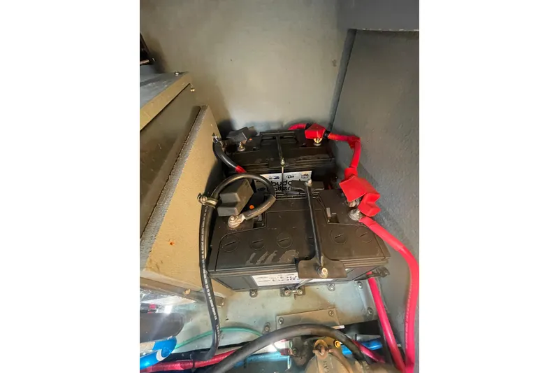 Slide: The Image of Battery compartment of a 2003 Sea Ray 340 Sundancer with connected cables. - 52