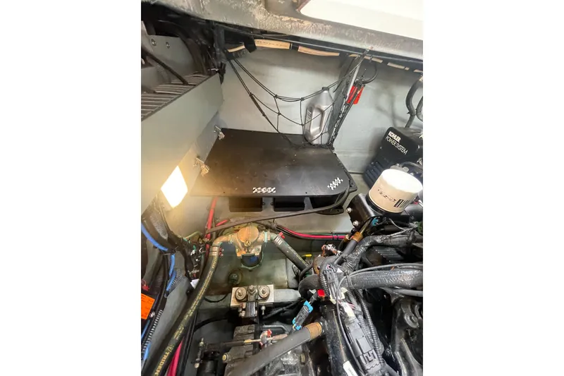 Slide: The Image of Engine compartment of a 2003 Sea Ray 340 Sundancer boat, showing mechanical components. - 53