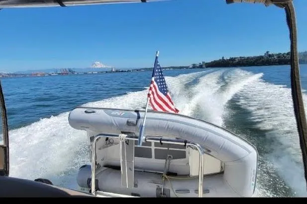 Slide: The Image of 2003 Sea Ray 340 Sundancer cruising with American flag, scenic ocean view. - 59