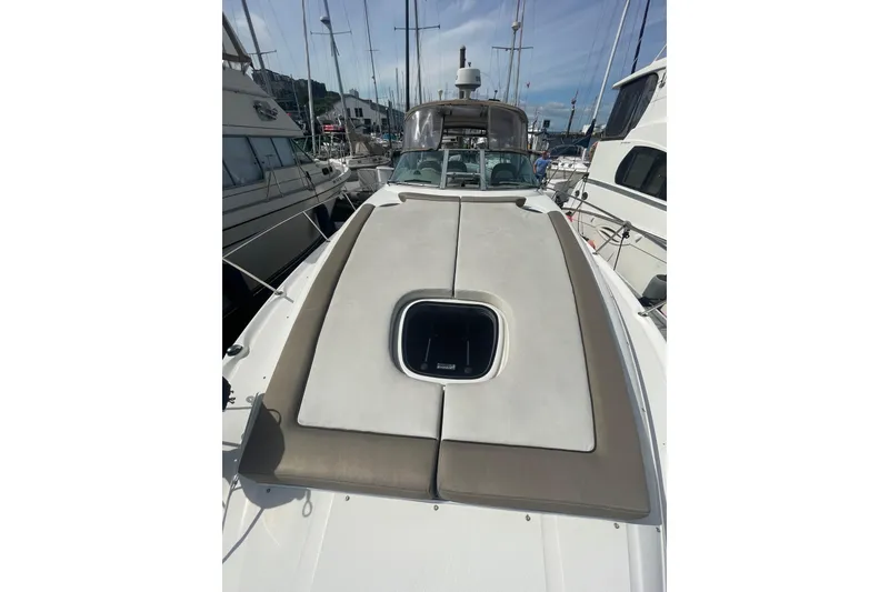 Slide: The Image of 2003 Sea Ray 340 Sundancer yacht docked, featuring a spacious sunpad and sleek design. - 8