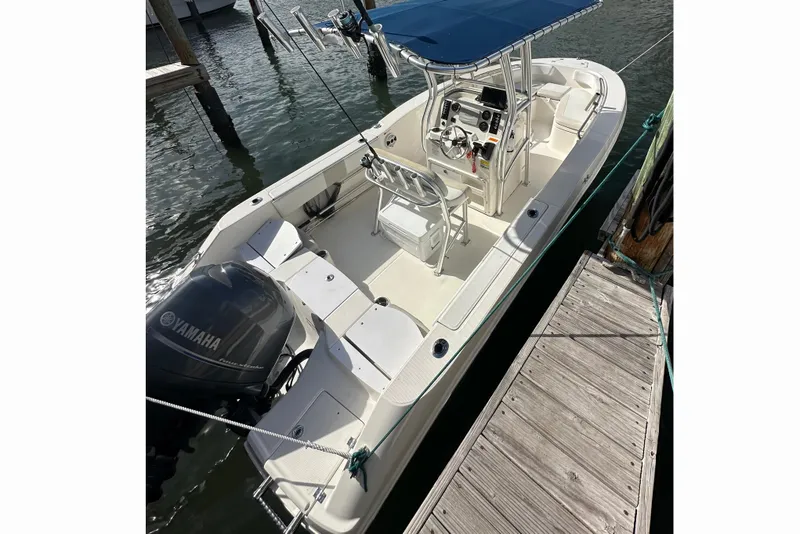 Slide: The Image of 2015 Robalo R200 Center Console boat docked, featuring Yamaha outboard motor. - 2