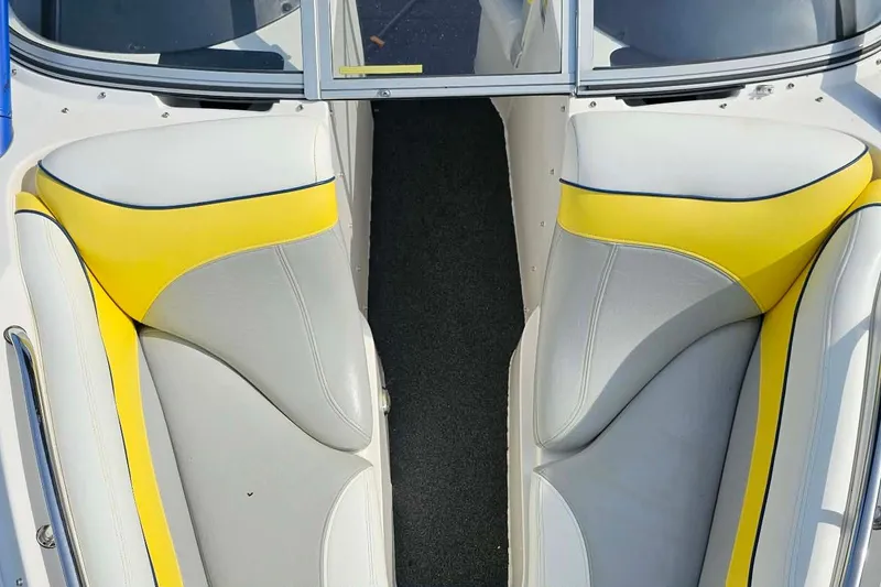 Slide: The Image of 2006 Tigé 22Ve boat interior with yellow and gray seating, showcasing modern design. - 16