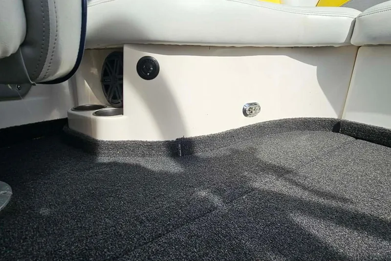 Slide: The Image of Interior of 2006 Tigé 22Ve boat showing carpet, speaker, and cup holders. - 21