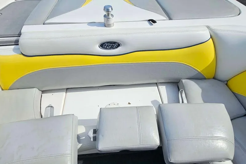 Slide: The Image of 2006 Tigé 22Ve boat interior with yellow and gray seating. - 22