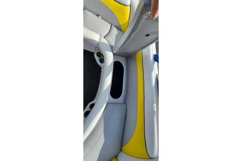 Slide: The Image of 2006 Tigé 22Ve boat interior with yellow and gray seating. - 23