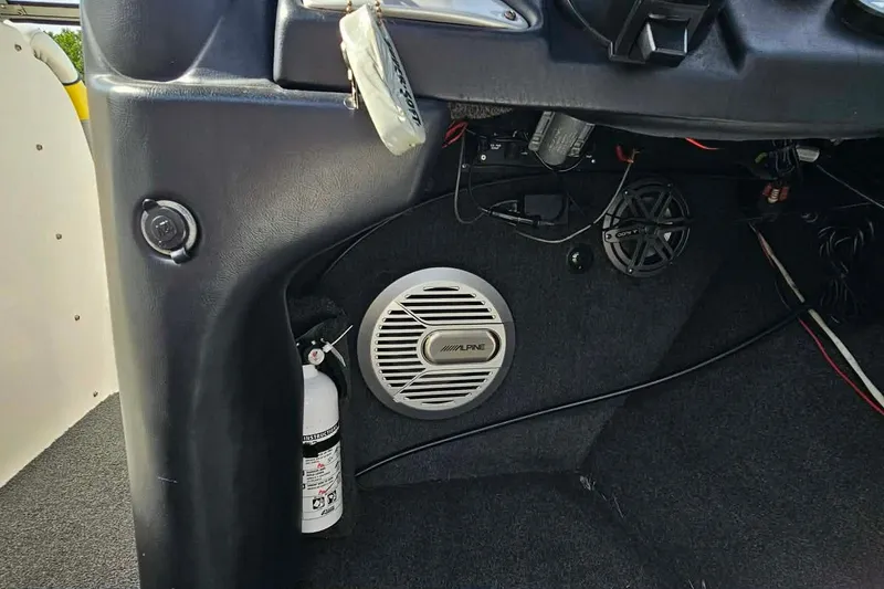 Slide: The Image of 2006 Tigé 22Ve interior with Alpine speaker and fire extinguisher. - 24