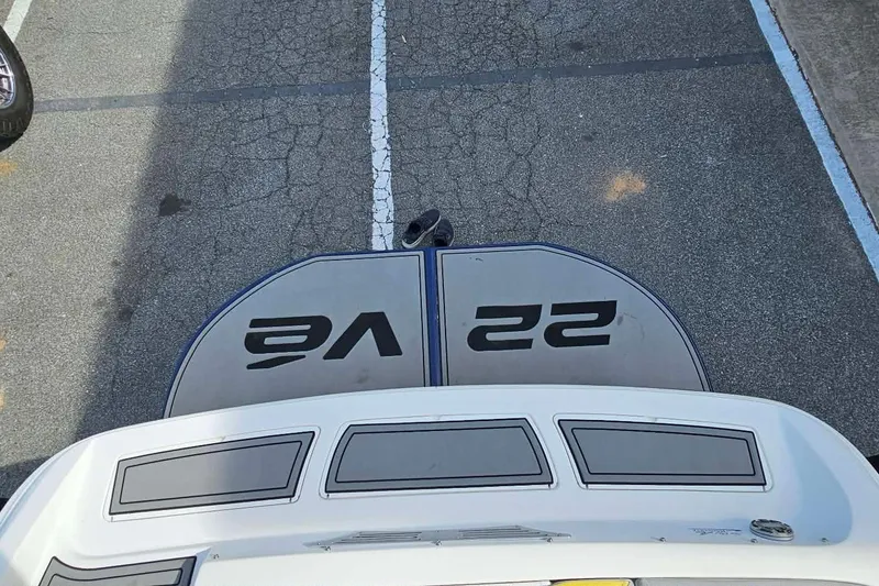 Slide: The Image of 2006 Tigé 22Ve boat parked on asphalt, showcasing rear deck and branding. - 25