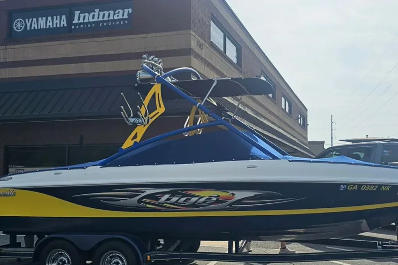 Slide: The Image of 2006 Tigé 22Ve boat with vibrant graphics, parked outside Yamaha Indmar building. - 9