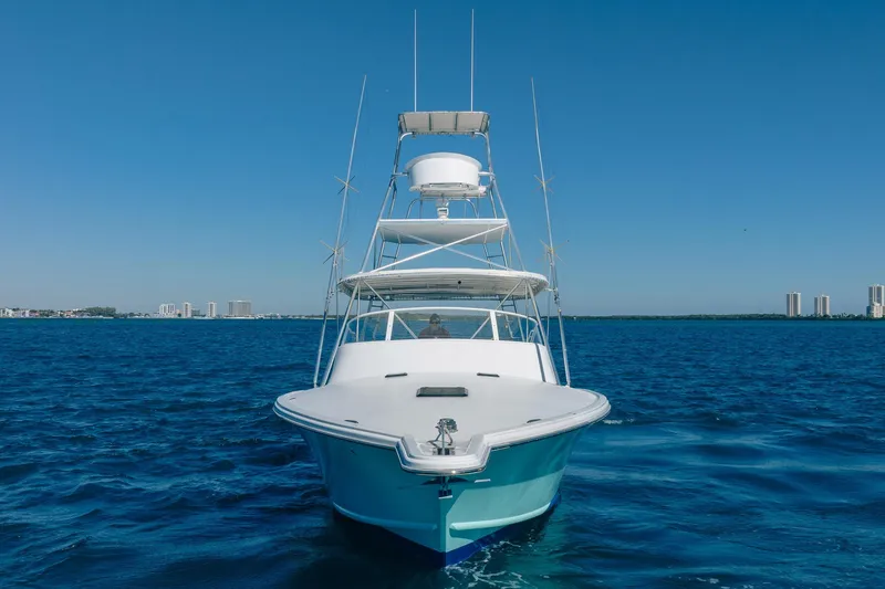 Slide: The Image of Front view of 1997 Strike 42 Express yacht on open blue water. - 2