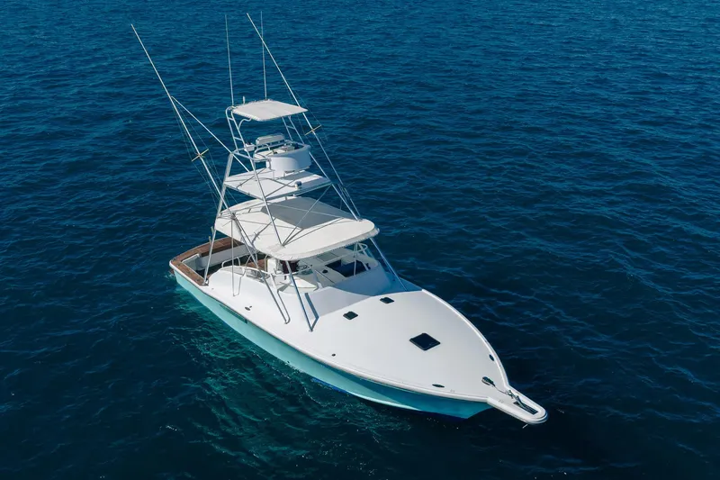 Slide: The Image of 1997 Strike 42 Express yacht on open blue sea, aerial view. - 4