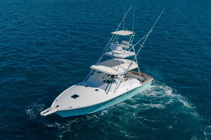 Slide: The Image of 1997 Strike 42 Express boat cruising on open blue ocean waters. - 7