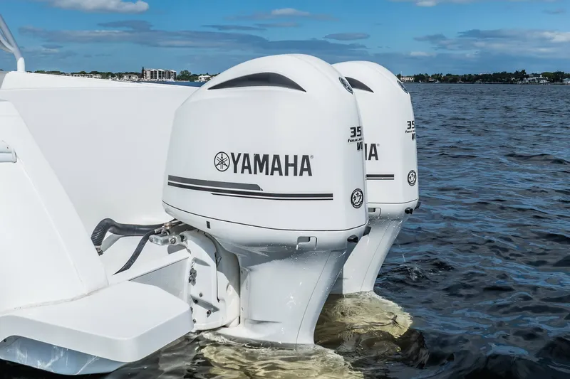 Slide: The Image of Twin Yamaha outboard engines on a 2011 Intrepid 400 Center Console boat in open water. - 9