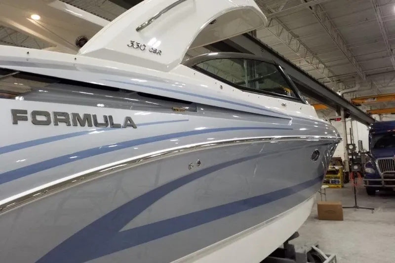 The Image of 2021 Formula 330 Crossover Bowrider in a showroom, showcasing sleek design and modern features. - 1