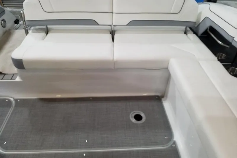 Slide: The Image of 2021 Formula 330 Crossover Bowrider interior seating with white upholstery and gray flooring. - 10