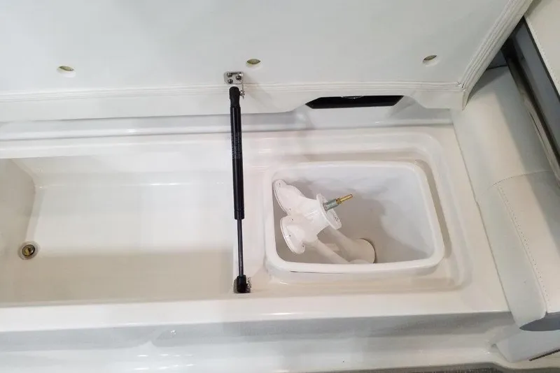 Slide: The Image of Storage compartment in 2021 Formula 330 Crossover Bowrider boat, featuring hydraulic lift support. - 14