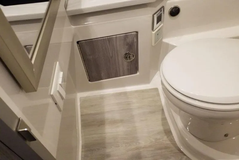 Slide: The Image of 2021 Formula 330 Crossover Bowrider bathroom with modern fixtures and wood accents. - 19