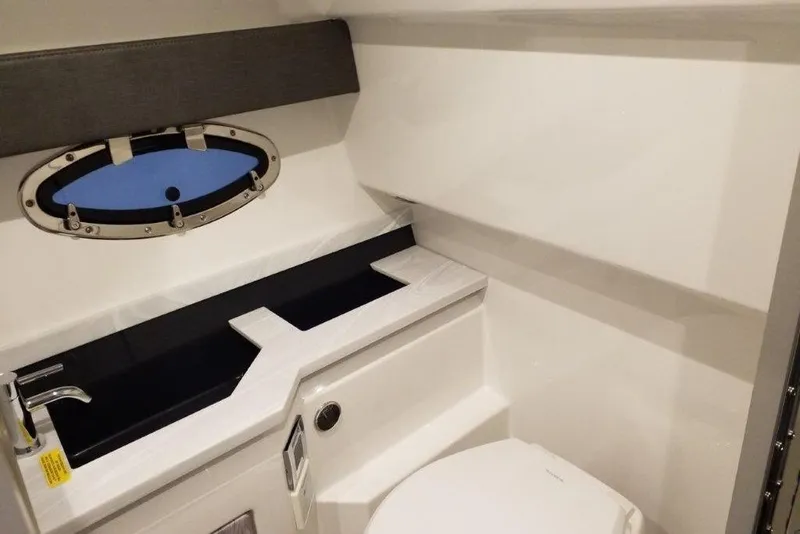 Slide: The Image of Interior of 2021 Formula 330 Crossover Bowrider bathroom with sink and porthole window. - 21