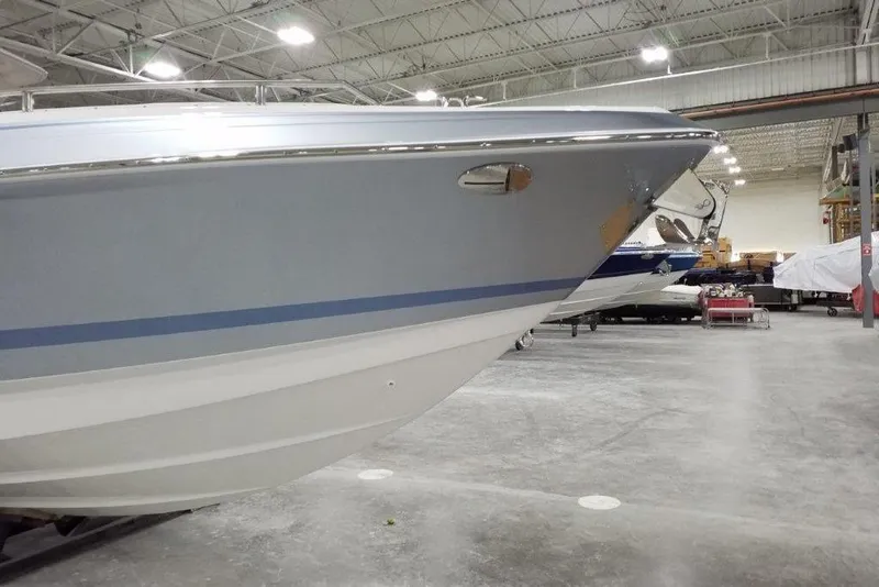 Slide: The Image of 2021 Formula 330 Crossover Bowrider in a spacious indoor showroom. - 3