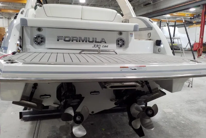 Slide: The Image of 2021 Formula 330 Crossover Bowrider boat rear view in a workshop setting. - 4