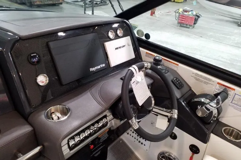 Slide: The Image of 2021 Formula 330 Crossover Bowrider dashboard with steering wheel and navigation controls. - 6