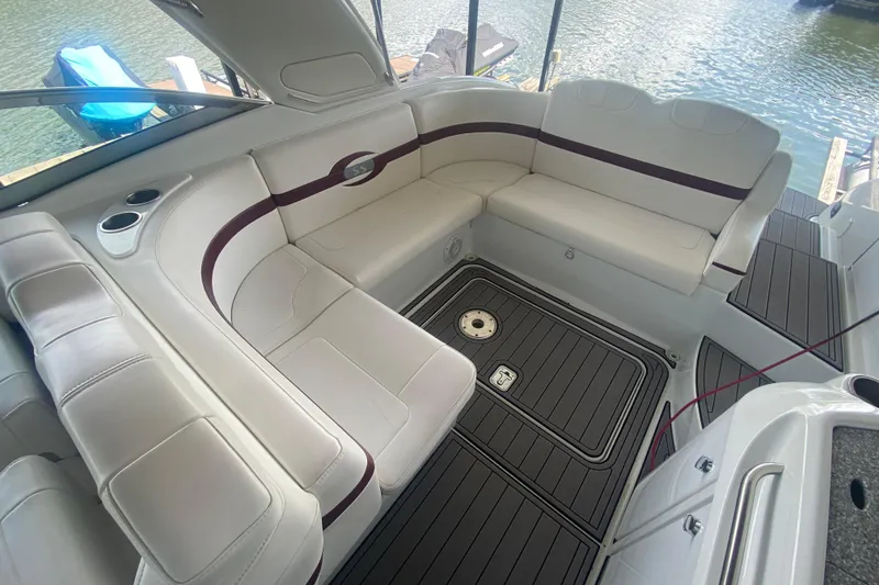 Slide: The Image of 2007 Formula 310 Sun Sport boat interior with white seating and wood-style flooring. - 13