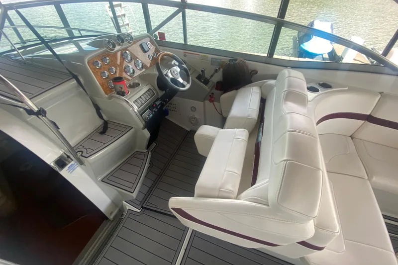 Slide: The Image of 2007 Formula 310 Sun Sport boat interior with white seating and wooden dashboard. - 14