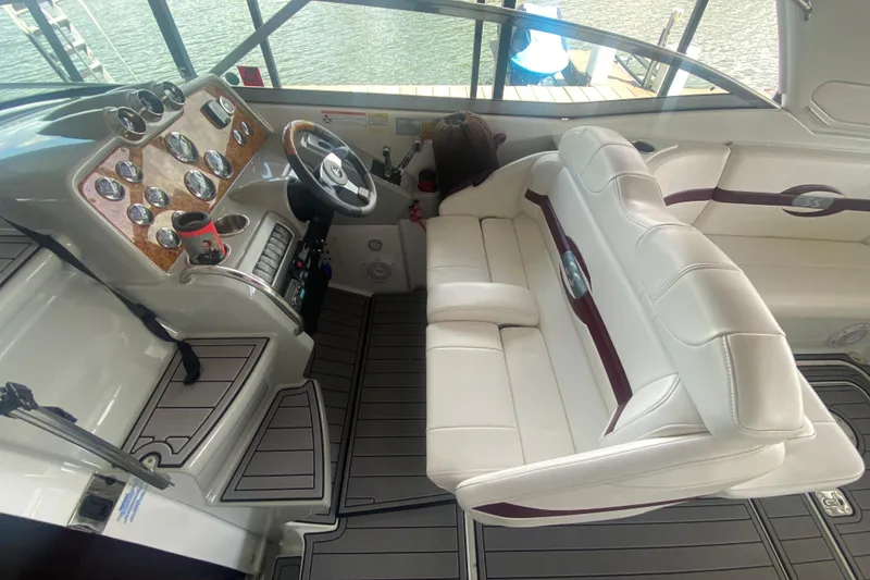 Slide: The Image of Interior of a 2007 Formula 310 Sun Sport boat with white seating and detailed dashboard. - 15