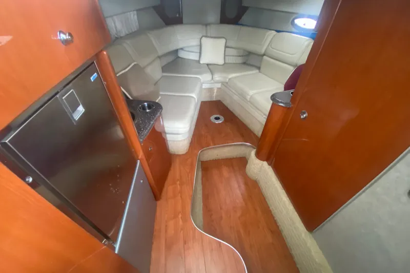 Slide: The Image of Luxurious interior of 2007 Formula 310 Sun Sport boat with plush seating and wood finishes. - 19