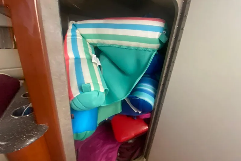 Slide: The Image of Colorful striped cushions stored inside a 2007 Formula 310 Sun Sport boat compartment. - 23